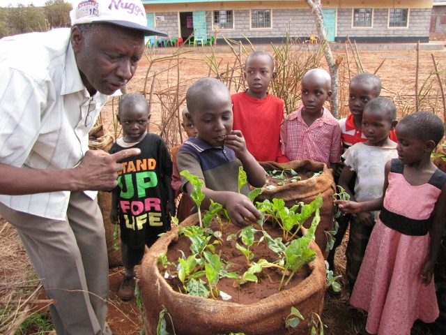 Children taste testing gunny sack garden produce at school