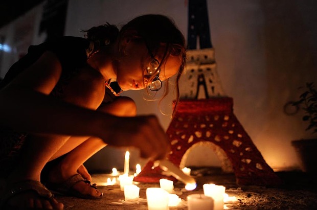 MANILA, PHILIPPINES - NOVEMBER 16:  A young girl lights candles to honour victims of the Paris terror attacks at Alliance Francais Manila on November 16, 2015 in Manila, Philippines. 129 people were killed and hundreds more injured in Paris following a series of terrorist acts in the French capital on Friday night.  (Photo by Dondi Tawatao/Getty Images) *** BESTPIX ***